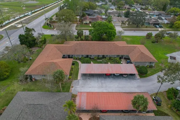 an aerial view of a house with a garden and lake view