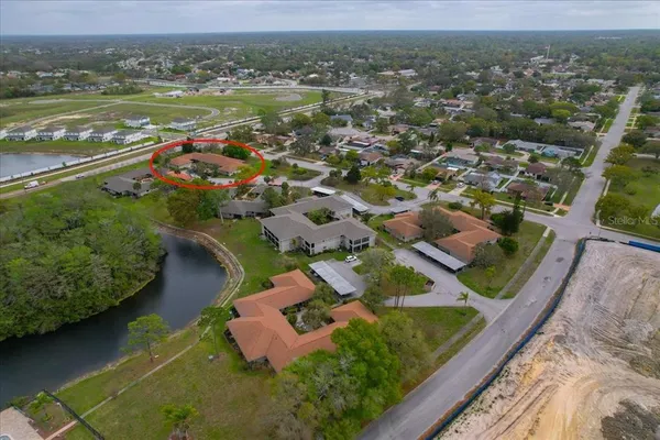 an aerial view of residential houses with outdoor space and river