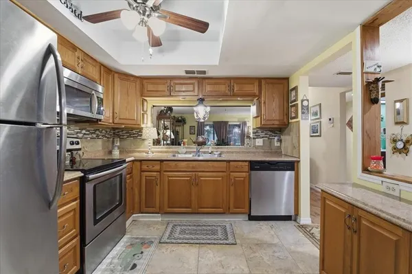 a kitchen with stainless steel appliances granite countertop a sink and stove top oven