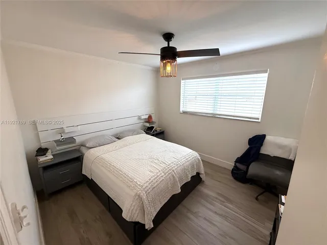 a bedroom with a bed and a ceiling fan