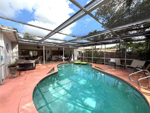 a view of a backyard with swimming pool