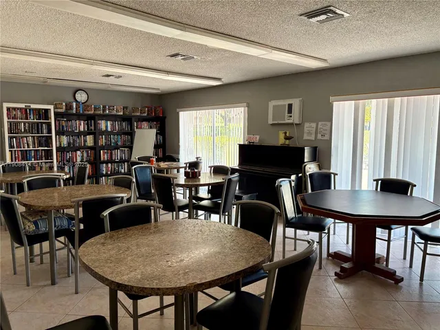 a view of a patio with dining table and chairs with a fire pit