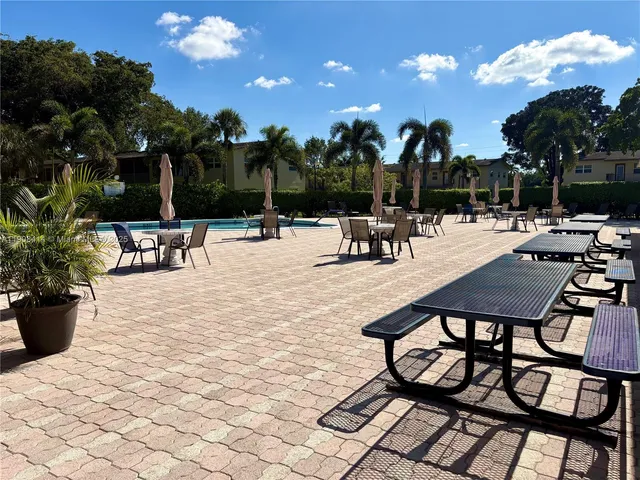 a view of a chairs and tables in the patio and potted plants