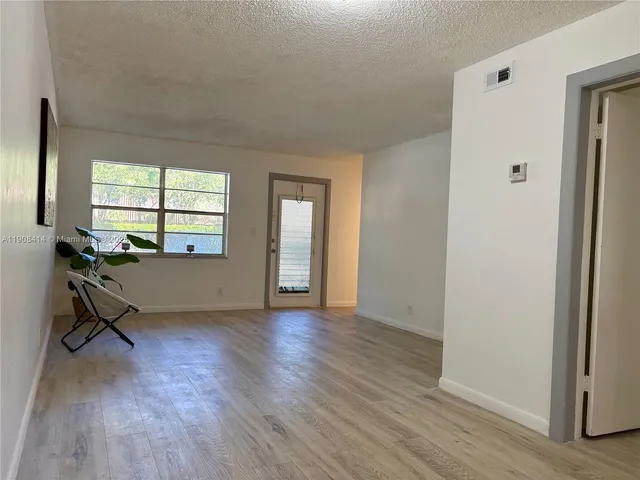 a view of a room window and wooden floor