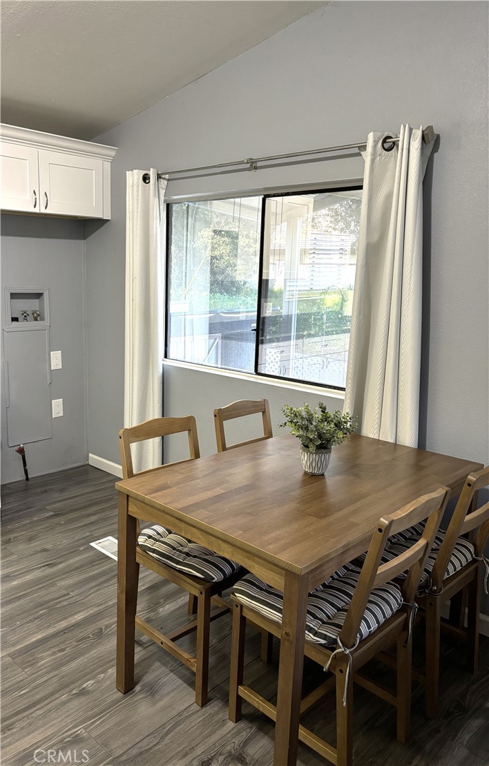 21515 Placerita Canyon Road, Unit 26 Newhall, CA 91321 - Photo 11 of 19 a view of a dining room with furniture and wooden floor