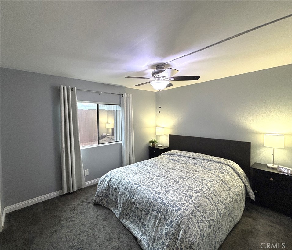 21515 Placerita Canyon Road, Unit 26 Newhall, CA 91321 - Photo 12 of 19 a bedroom with a bed and a chandelier