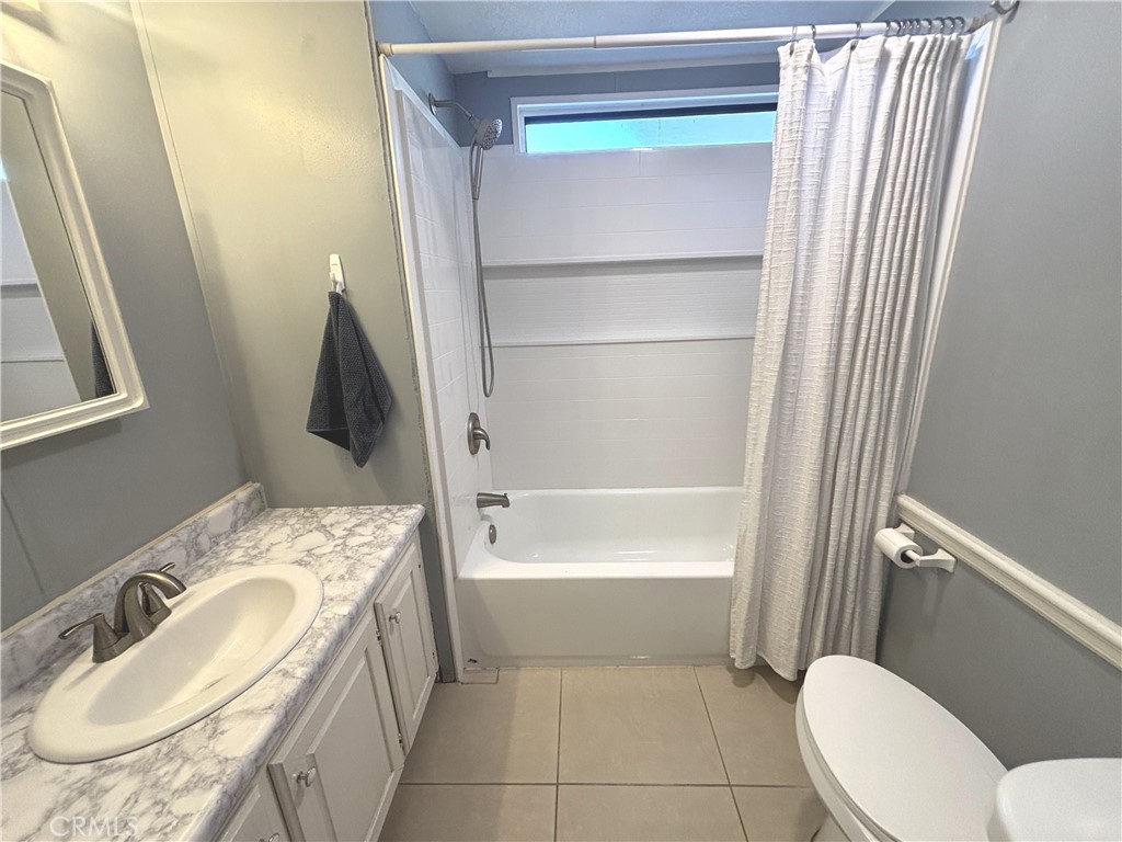 21515 Placerita Canyon Road, Unit 26 Newhall, CA 91321 - Photo 14 of 19 a bathroom with a granite countertop sink and a mirror