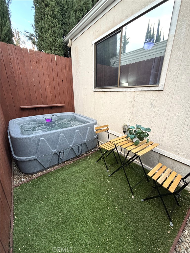 21515 Placerita Canyon Road, Unit 26 Newhall, CA 91321 - Photo 16 of 19 a view of a backyard with chairs and a garden