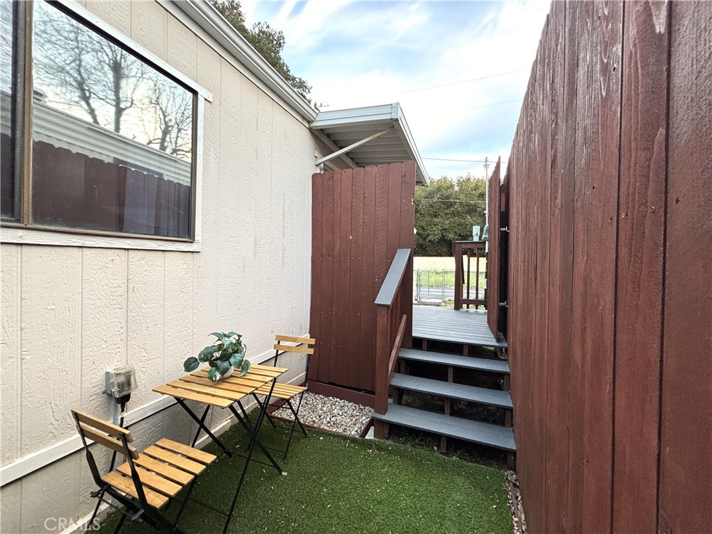 21515 Placerita Canyon Road, Unit 26 Newhall, CA 91321 - Photo 18 of 19 a backyard of a house with table and chairs