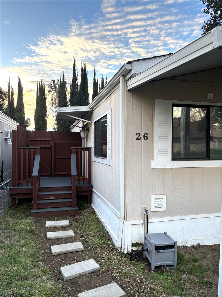21515 Placerita Canyon Road, Unit 26 Newhall, CA 91321 - Photo 3 of 19 a front view of a house with a yard