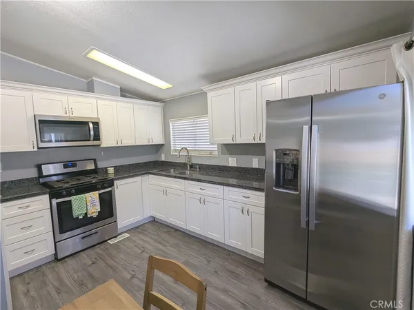 a kitchen with a refrigerator stove and microwave