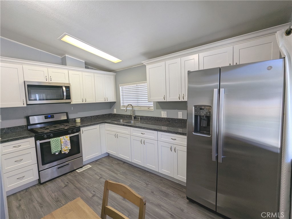 21515 Placerita Canyon Road, Unit 26 Newhall, CA 91321 - Photo 5 of 19 a kitchen with a refrigerator stove and microwave