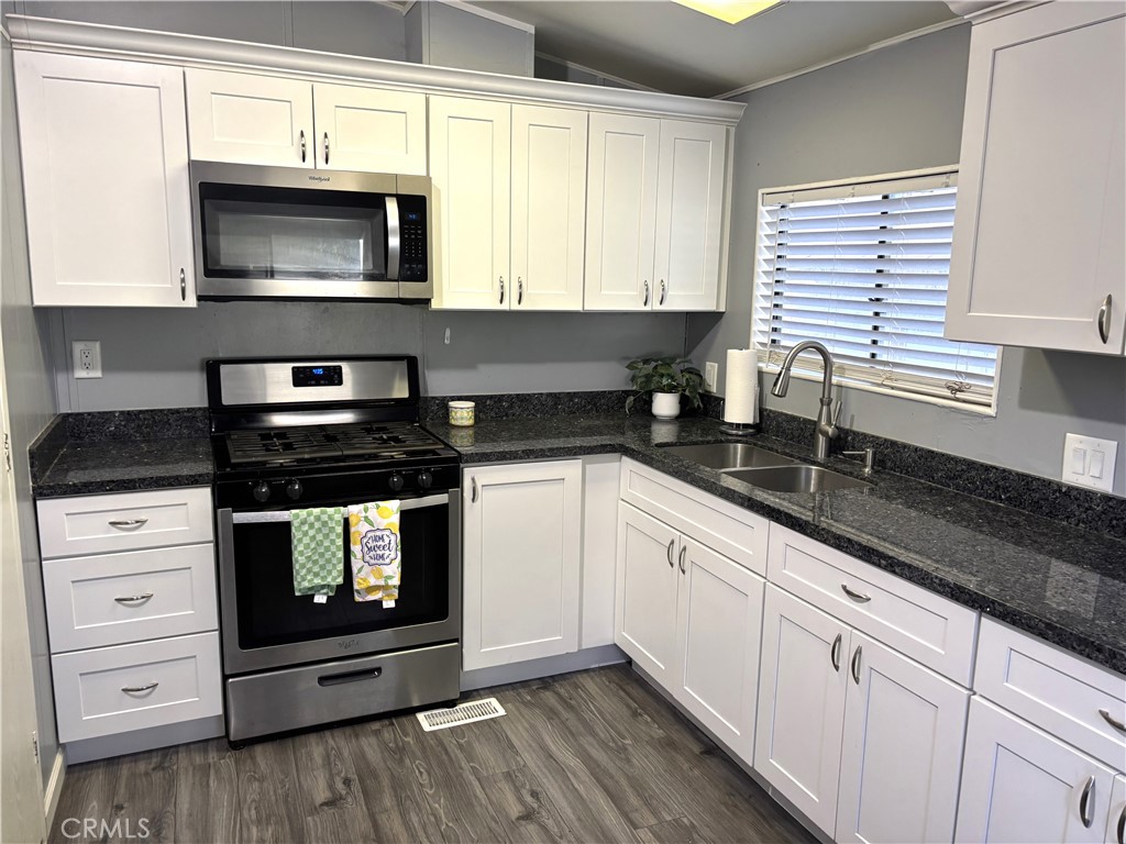21515 Placerita Canyon Road, Unit 26 Newhall, CA 91321 - Photo 7 of 19 a kitchen with stainless steel appliances granite countertop white cabinets granite counter tops and a window