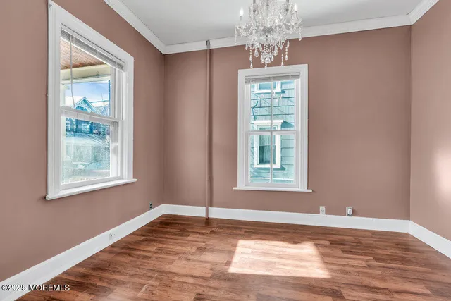 a view of a hallway to rooms and stairs