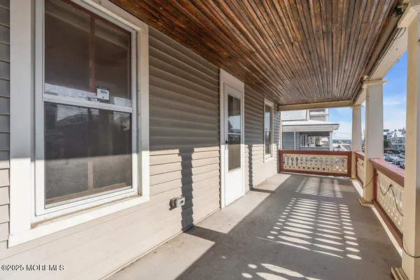 a view of a balcony with wooden floor