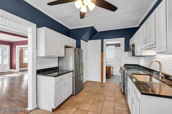 a kitchen with a stove a sink and a refrigerator