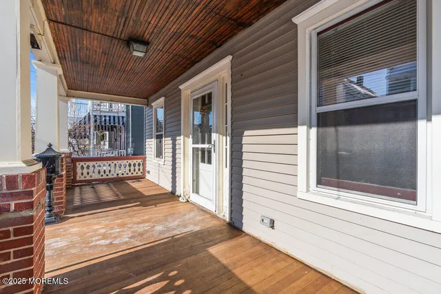 a view of an empty room window and wooden floor