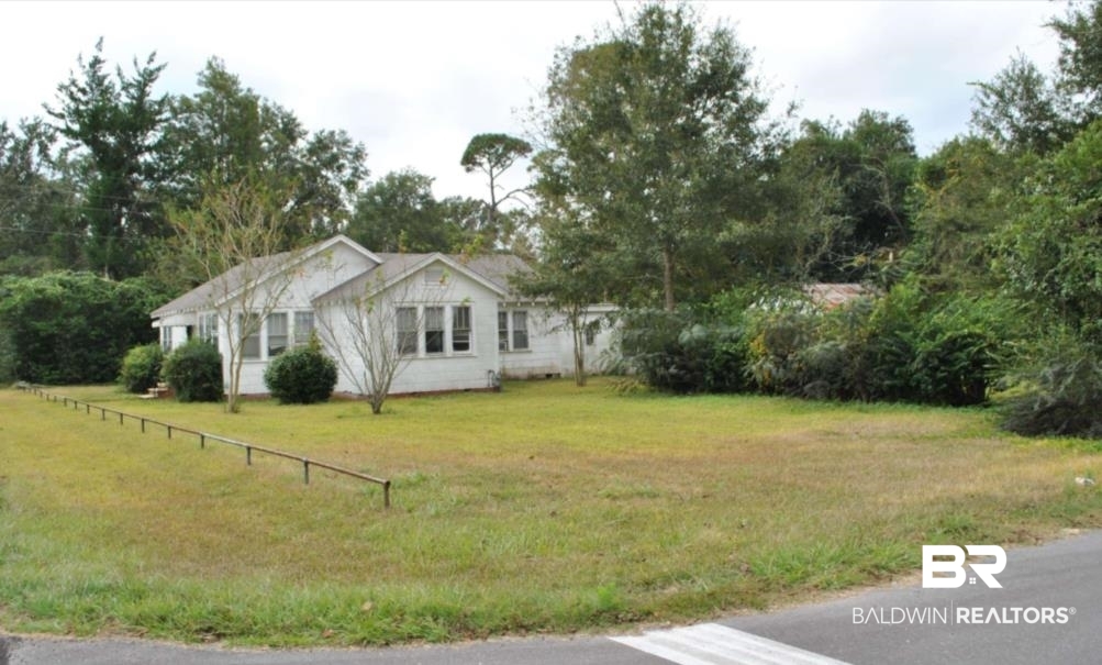 1059 Alabama Street Loxley, AL 36551 - Photo 4 of 12 View of property exterior featuring a lawn