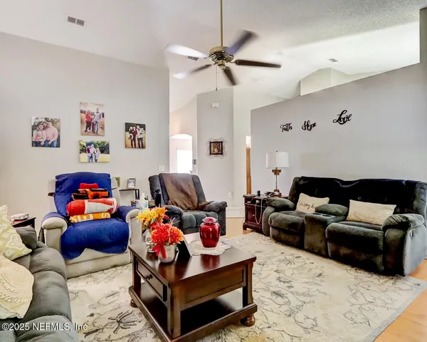 a living room with furniture and wooden floor