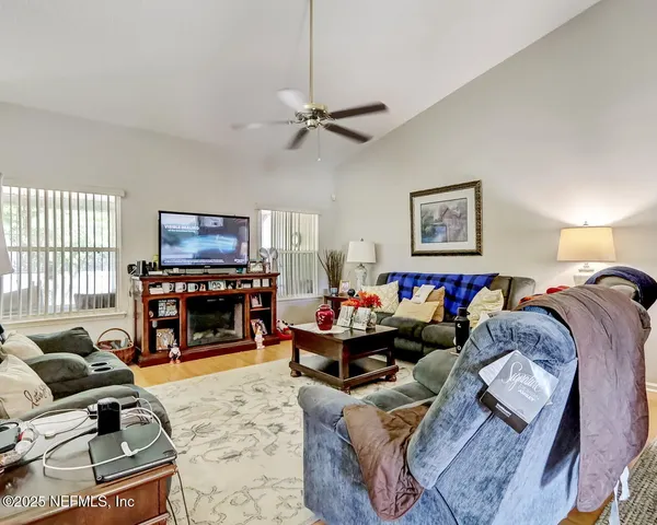 a living room with furniture a fireplace and a flat screen tv