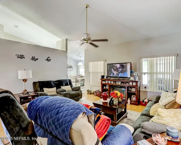 a living room with furniture a fireplace and a flat screen tv