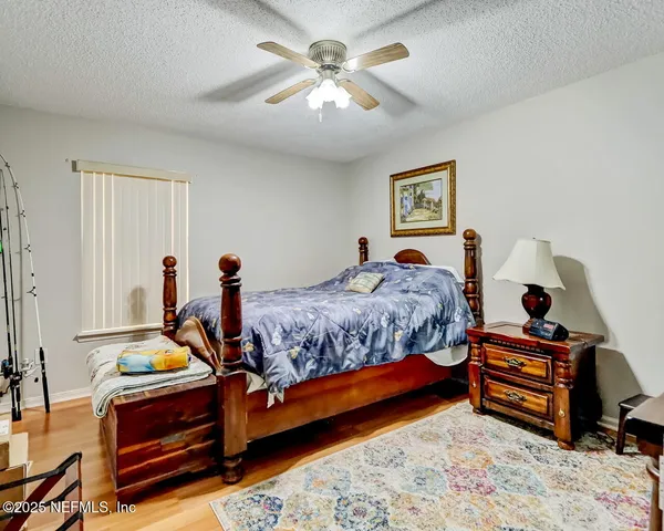 a bedroom with bed and a chandelier