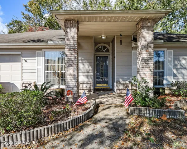 a view of a house with a porch and furniture