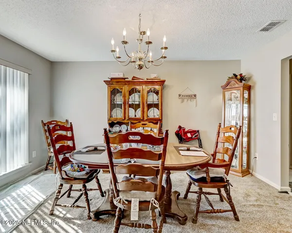a dining room with furniture and window
