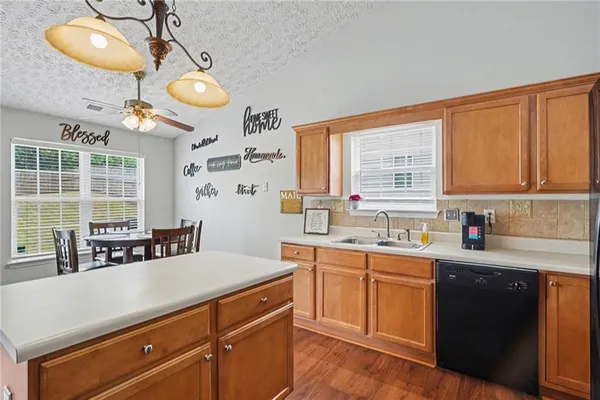 a kitchen with stainless steel appliances a sink a stove and a window