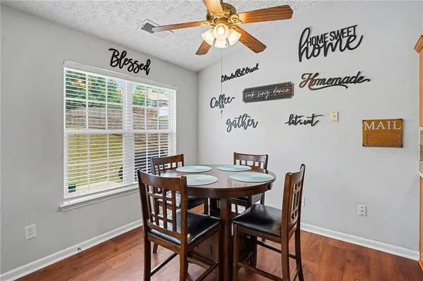 a view of a dining room with furniture and wooden floor