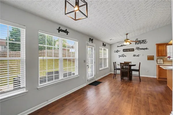 a view of a dining room with furniture window and wooden floor