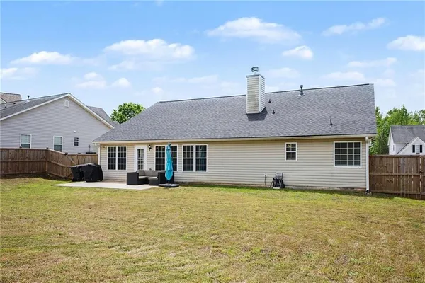 a front view of a house with yard and glass windows