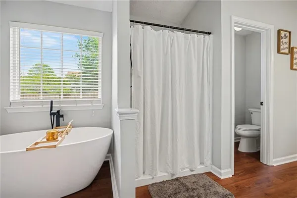 a bath tub sitting in a bathroom next to a window