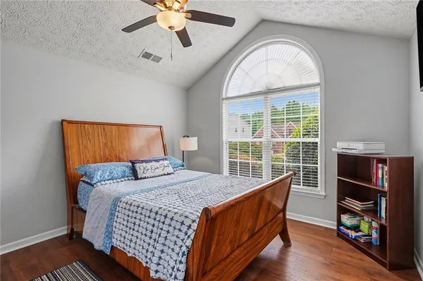 a bed sitting in a bedroom next to a window