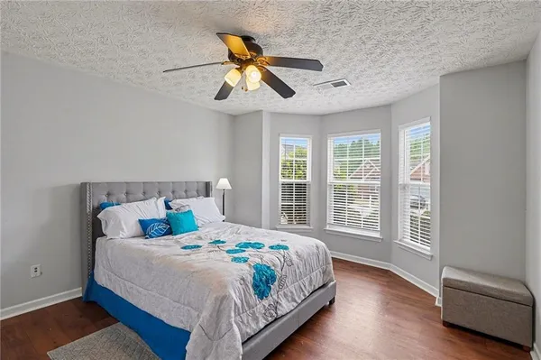 a bedroom with a large bed and a chandelier