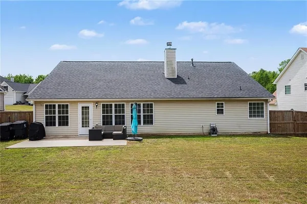a front view of a house with a garden and yard