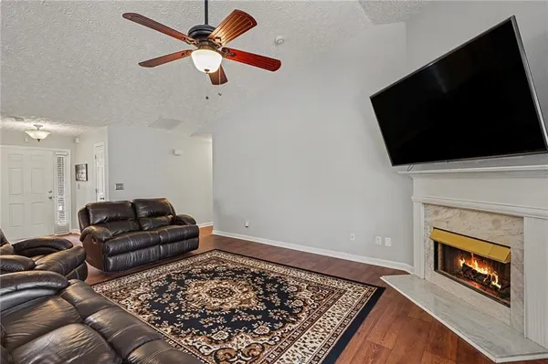 a living room with furniture and a fireplace