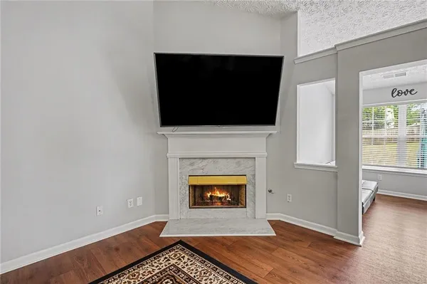a living room with a fireplace and a flat screen tv