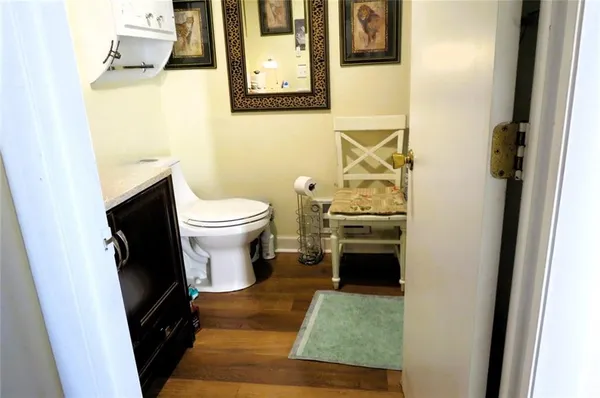 a view of a hallway with wooden floor and stairs