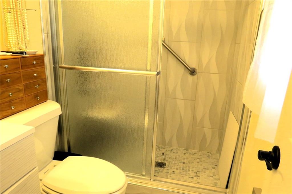 4880 Pea Ridge Road Cornelia, GA 30531 - Photo 17 of 34 a bathroom with a toilet sink and shower