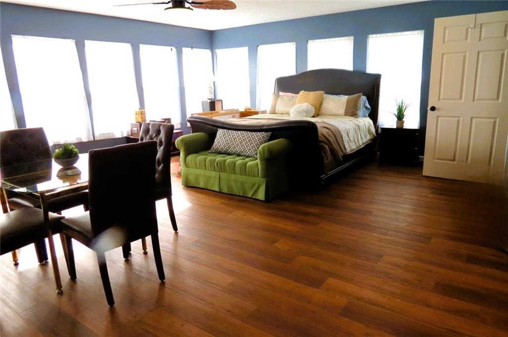 4880 Pea Ridge Road Cornelia, GA 30531 - Photo 22 of 34 a bedroom with a bed and wooden floor