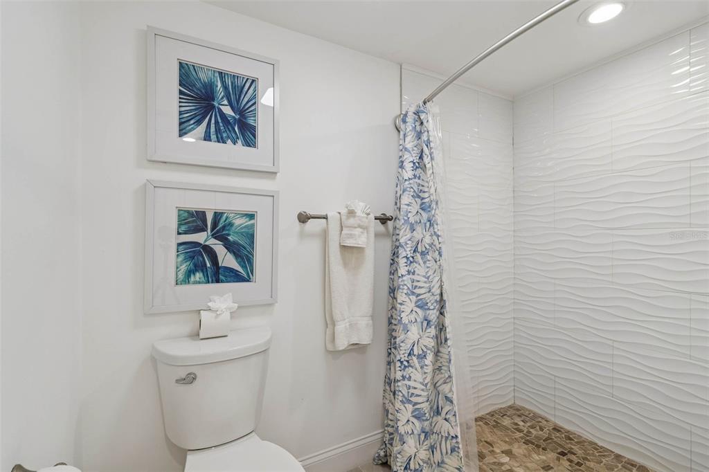 14600 Gulf Boulevard, Unit 102 Madeira Beach, FL 33708 - Photo 18 of 46 a bathroom with a toilet and a shower