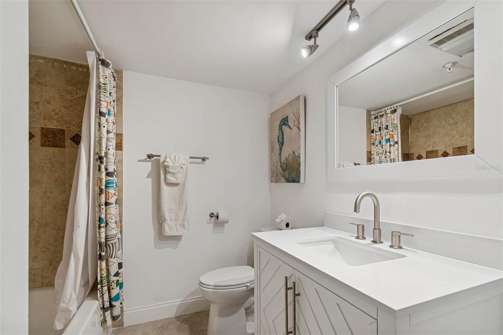 14600 Gulf Boulevard, Unit 102 Madeira Beach, FL 33708 - Photo 21 of 46 a bathroom with a sink toilet and shower