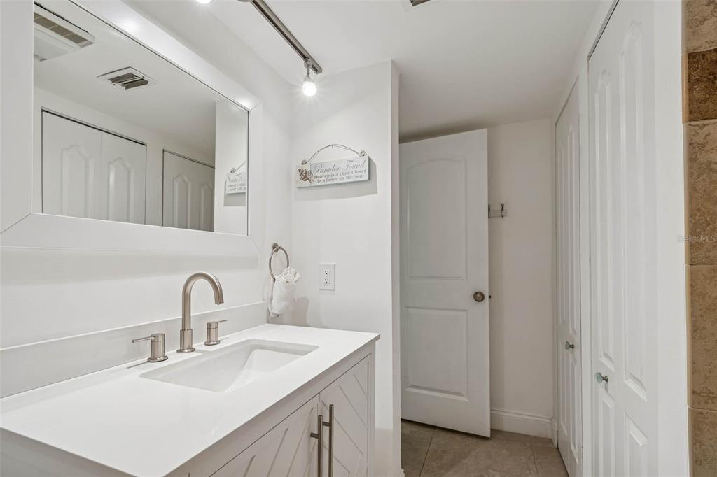 14600 Gulf Boulevard, Unit 102 Madeira Beach, FL 33708 - Photo 22 of 46 a bathroom with a sink and a mirror