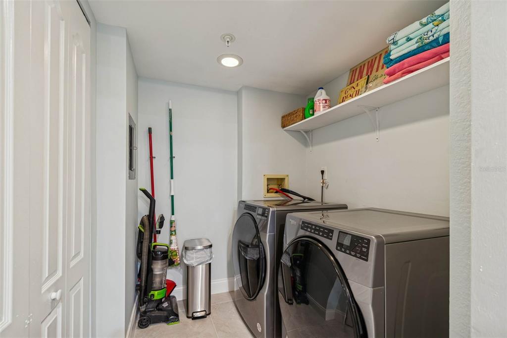 14600 Gulf Boulevard, Unit 102 Madeira Beach, FL 33708 - Photo 23 of 46 a utility room with dryer and washer
