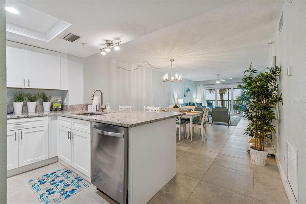 14600 Gulf Boulevard, Unit 102 Madeira Beach, FL 33708 - Photo 3 of 46 a kitchen with a sink and cabinets