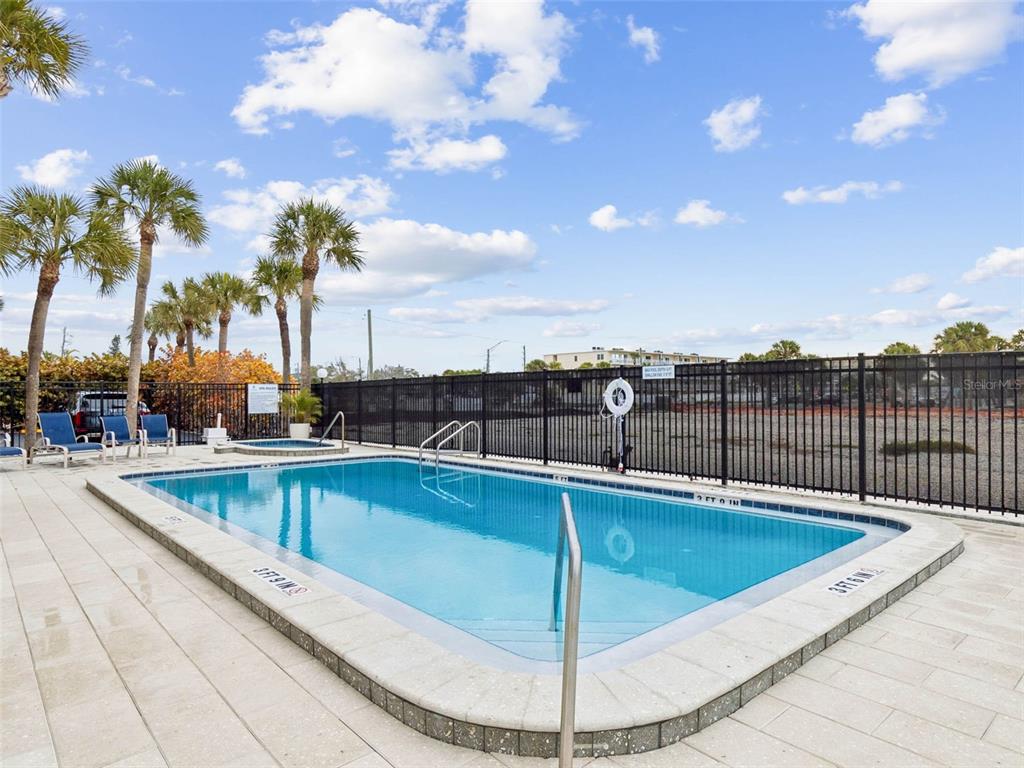 14600 Gulf Boulevard, Unit 102 Madeira Beach, FL 33708 - Photo 31 of 46 a view of a swimming pool with a chair
