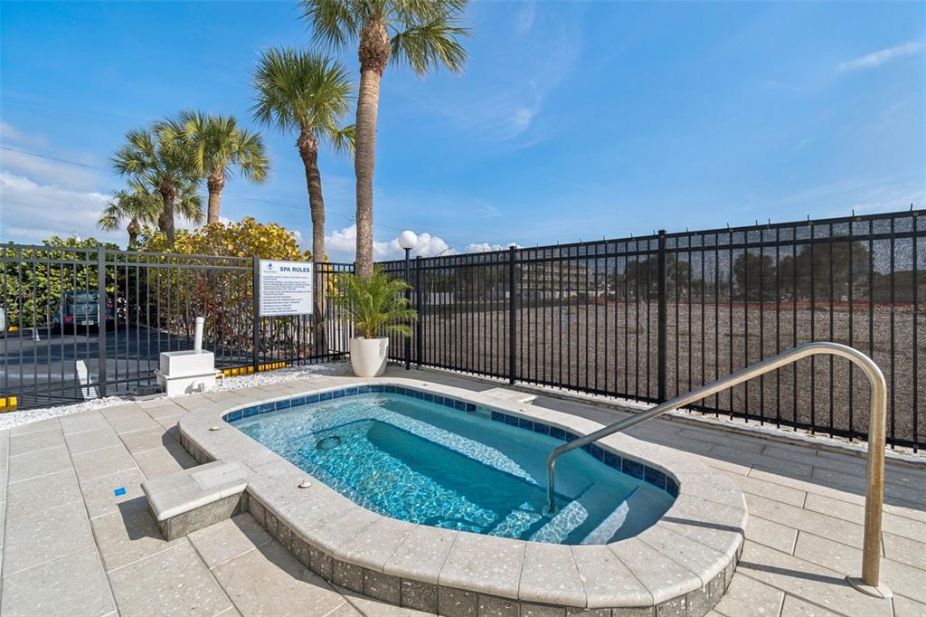 14600 Gulf Boulevard, Unit 102 Madeira Beach, FL 33708 - Photo 33 of 46 a view of a swimming pool with a lounge chair