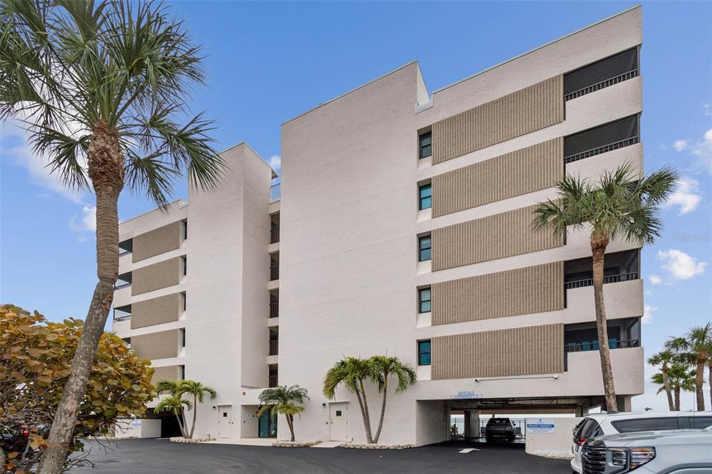 14600 Gulf Boulevard, Unit 102 Madeira Beach, FL 33708 - Photo 41 of 46 a view of balcony with potted plants and palm trees