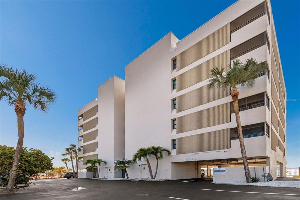14600 Gulf Boulevard, Unit 102 Madeira Beach, FL 33708 - Photo 42 of 46 a front view of a building with a street